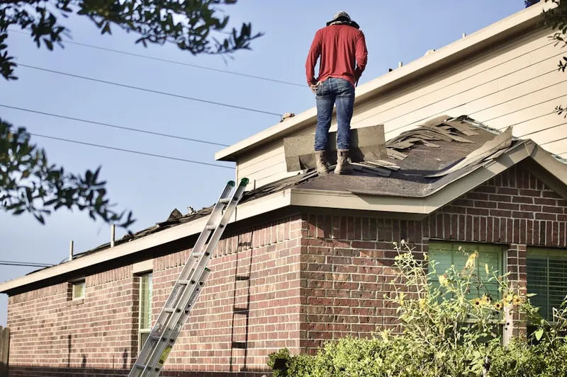Professional roofer working on a residential roof in The Marketplace at Vernon Hills